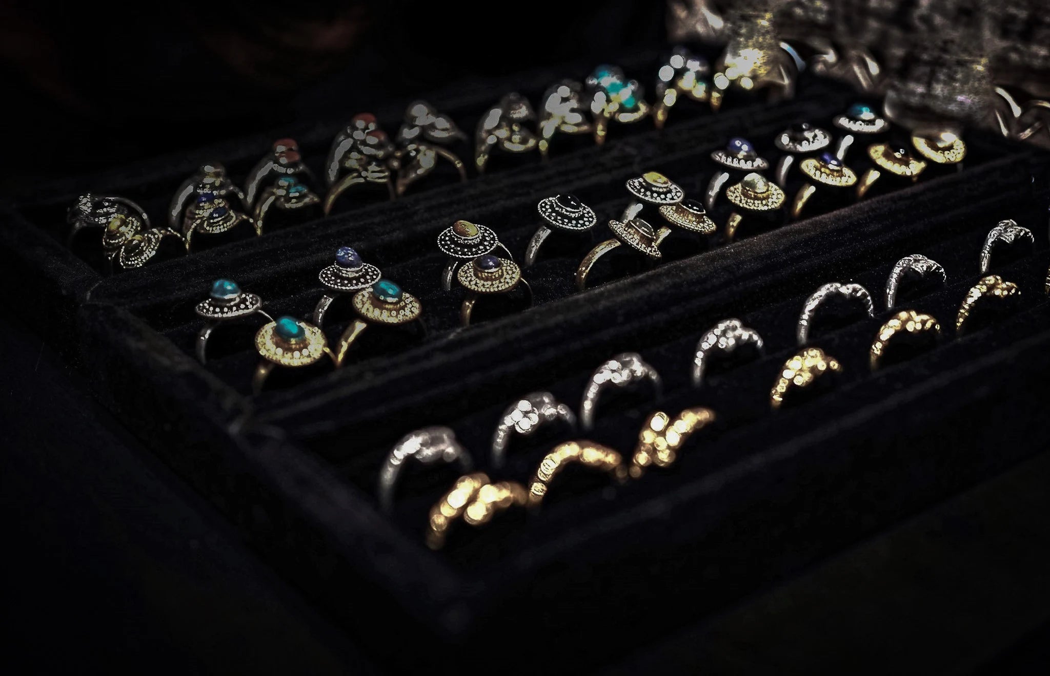 brass rings with stones displaid in black boxes