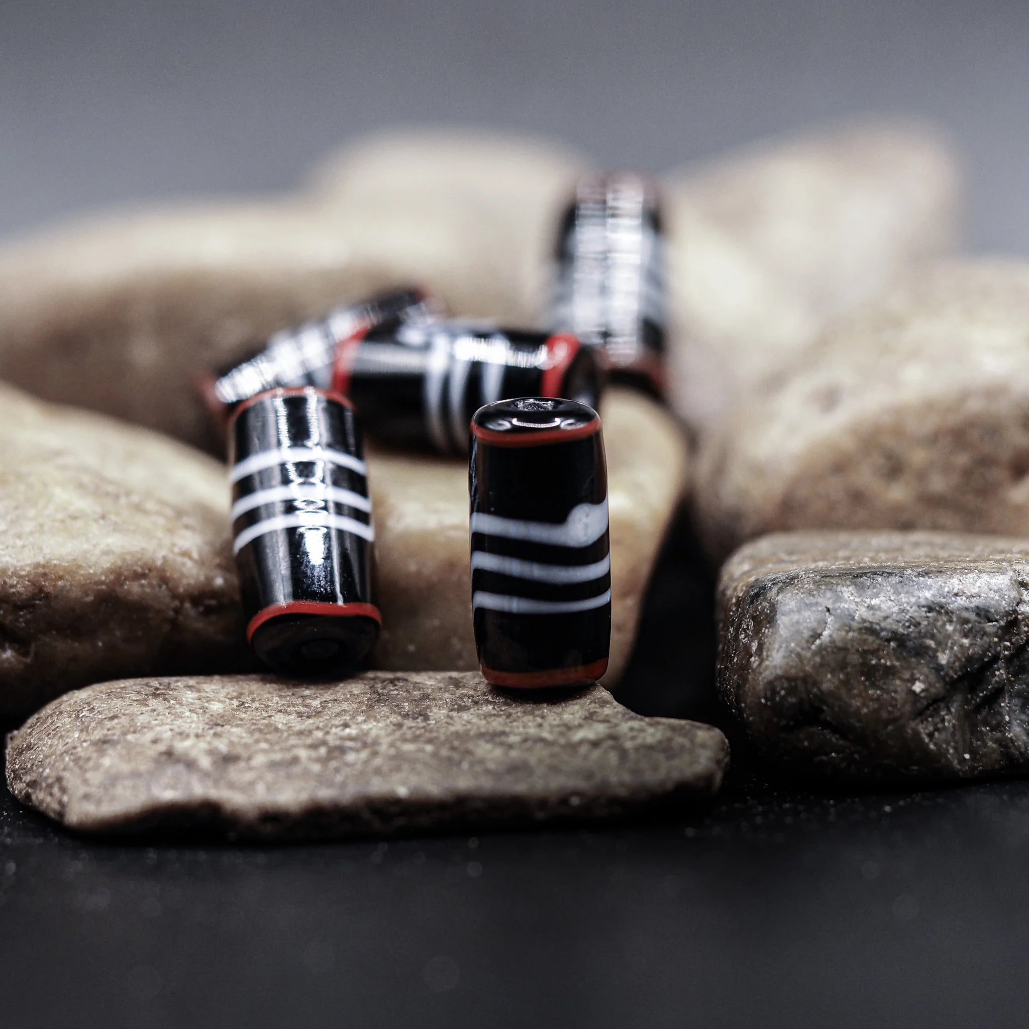 Black glass bead with grey/red decor, 100 grams