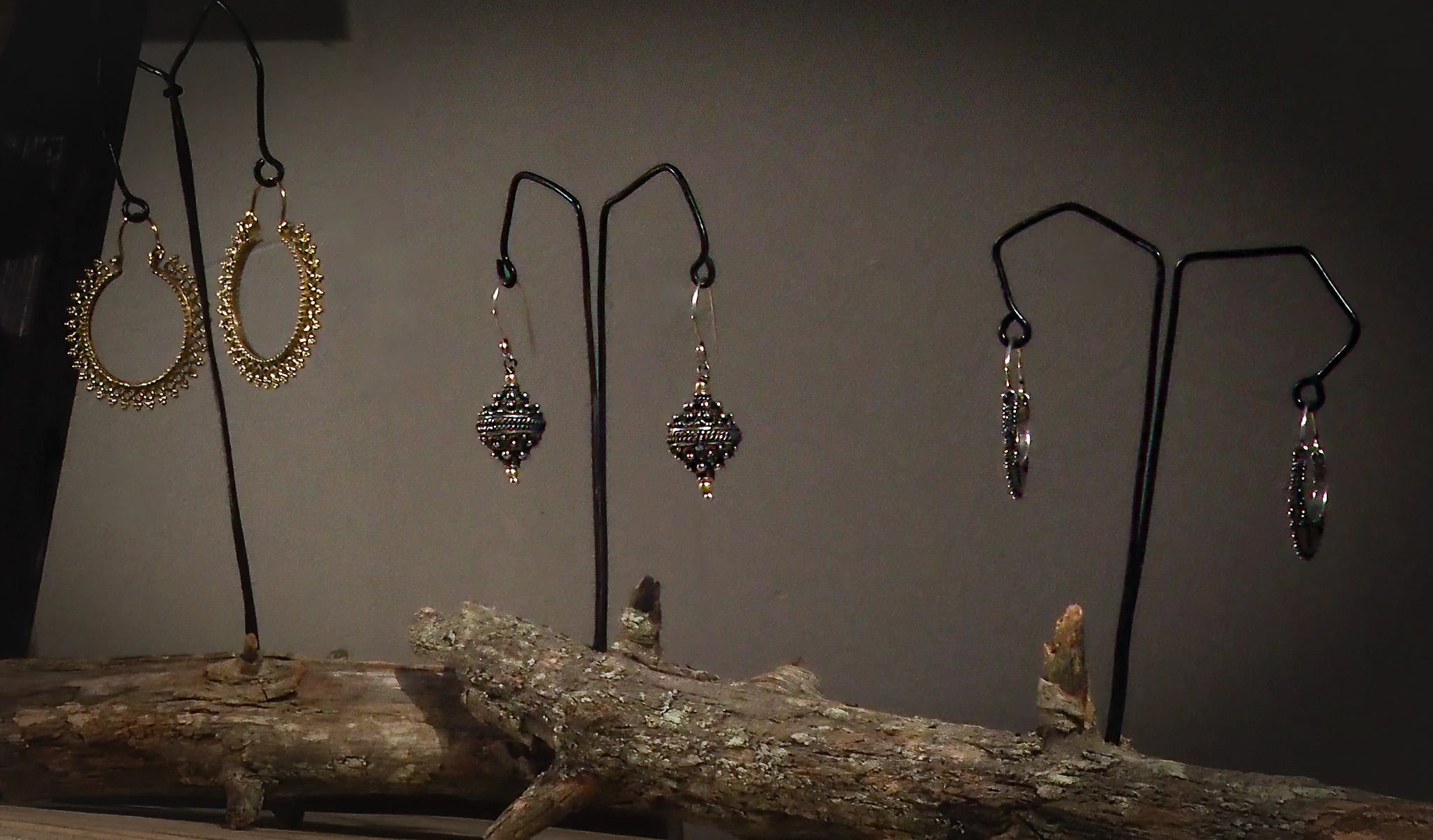 earrings displayed on metall hooks in a shop window