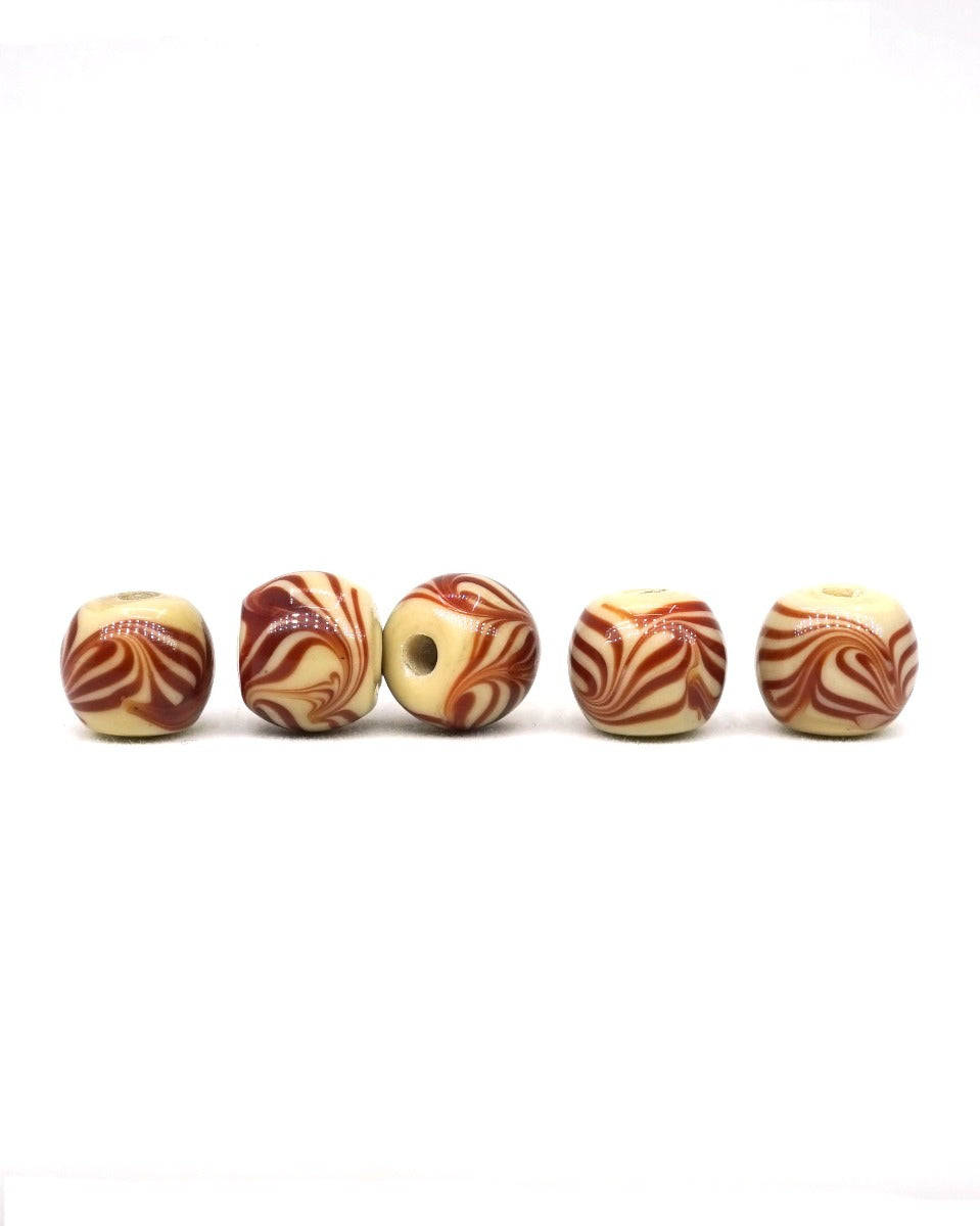 Beige glass bead with brown decoration, glossy