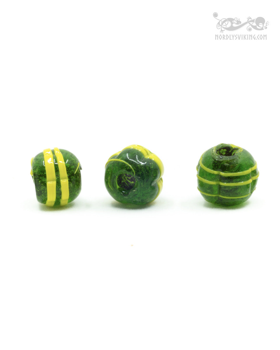 Dark green melon-shaped glass bead with yellow decor